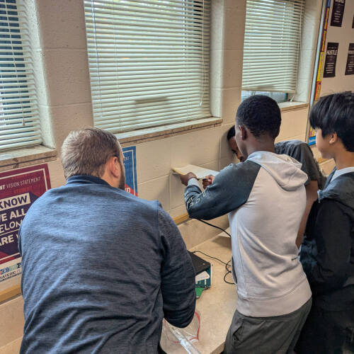 8th graders engaging in an engineering design activity
